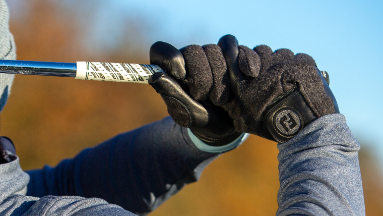 a-golfer-wearing-black-footjoy-winter-gloves