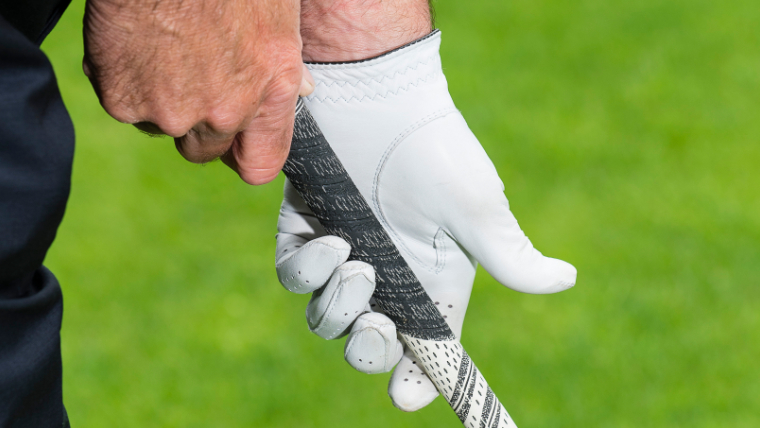 a-close-up-of-a-golfer-wearing-a-glove-and-holding-a-golf-grip