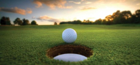 Golf ball teetering on the edge of a hole